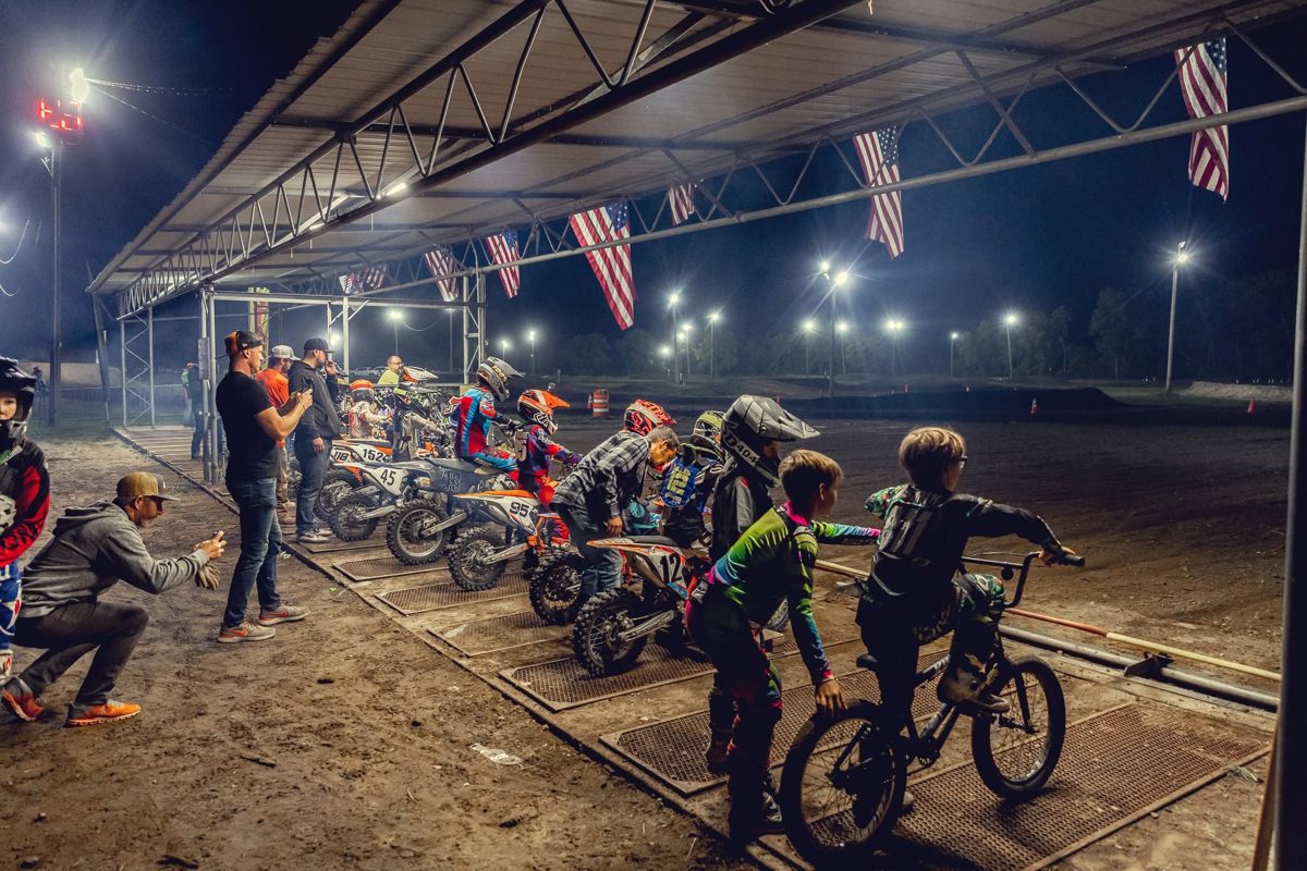 Children and balance bike riders at a Joliet MX track event