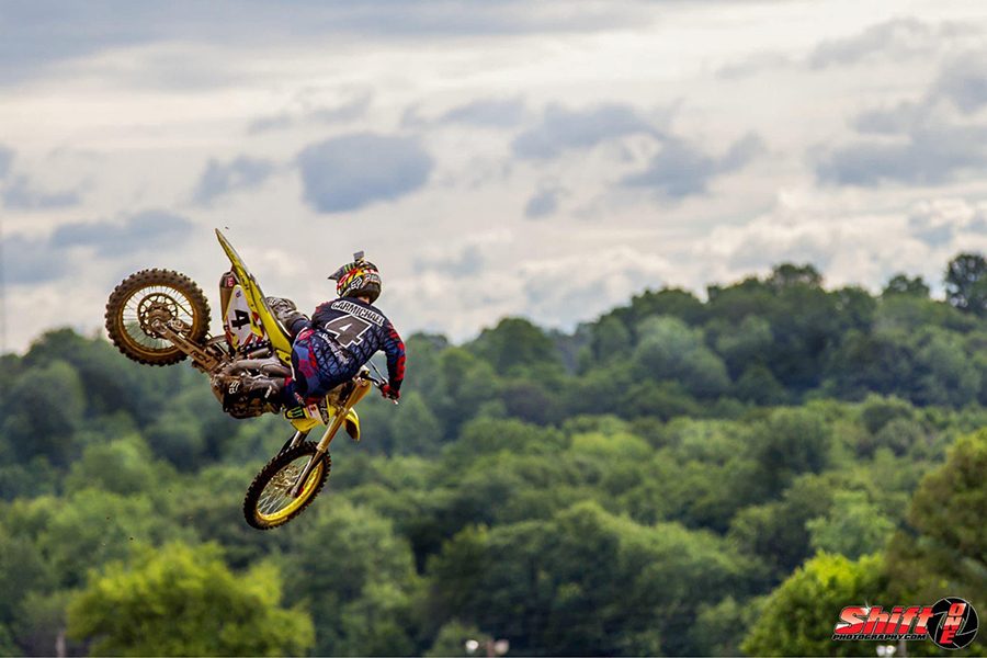 Motocross rider jumping against the sky