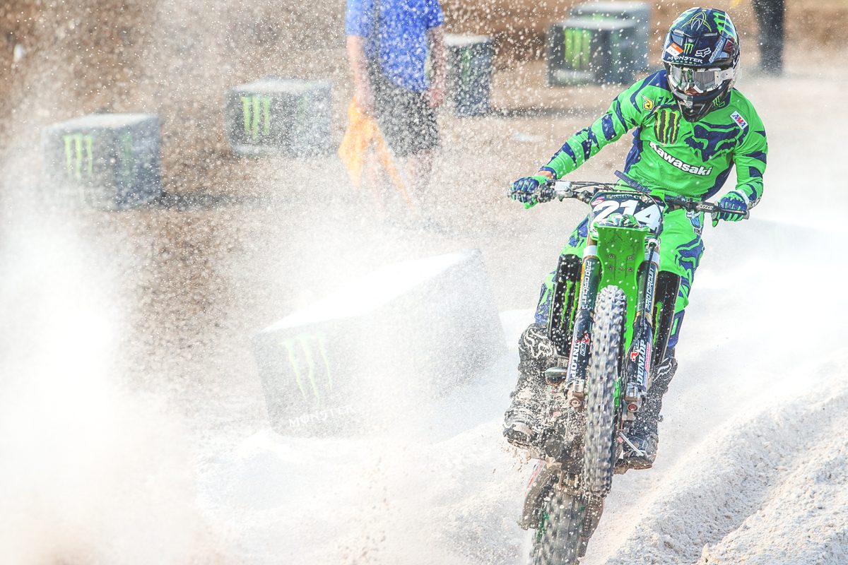 Rider navigating a wet motocross course