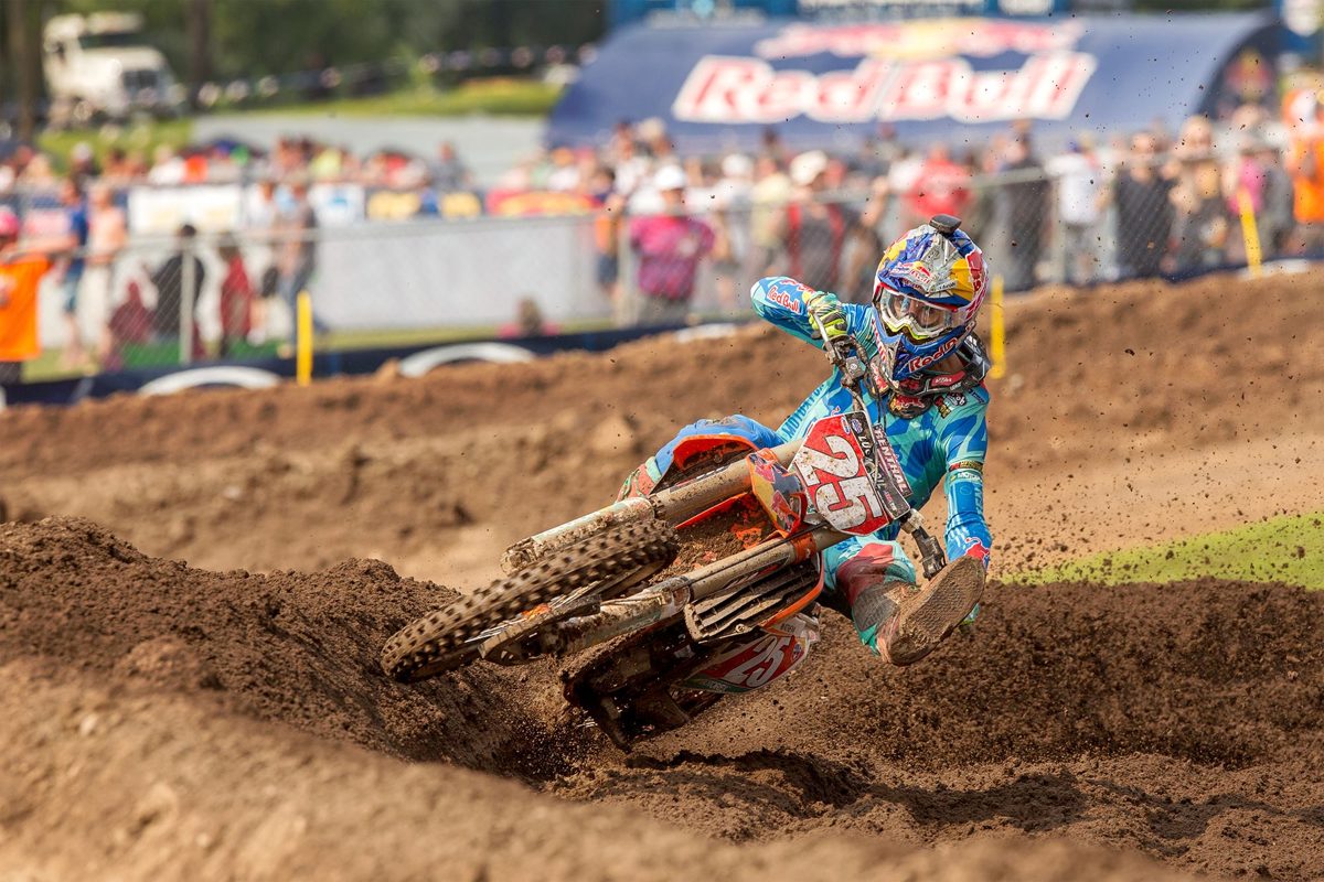 Motocross rider riding through a berm